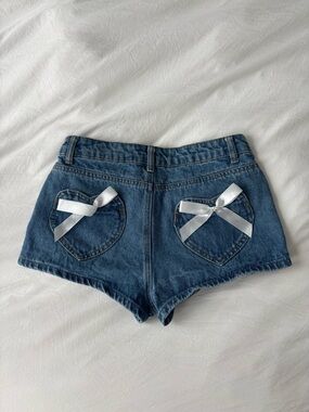 Edikted Denim Shorts with Heart Pockets & Bow Detail